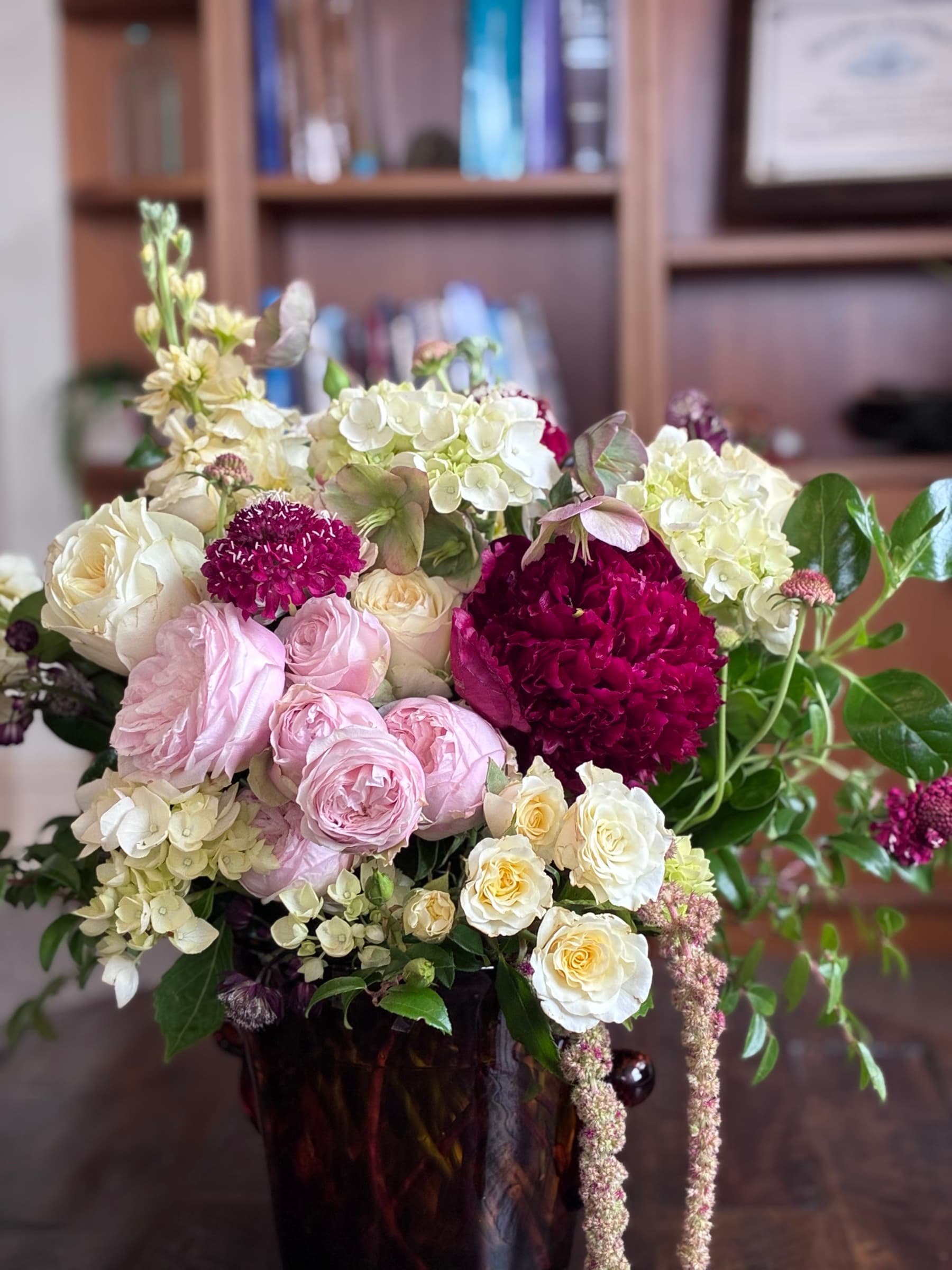 Pink roses, burgundy carnations and trailing amaranthus