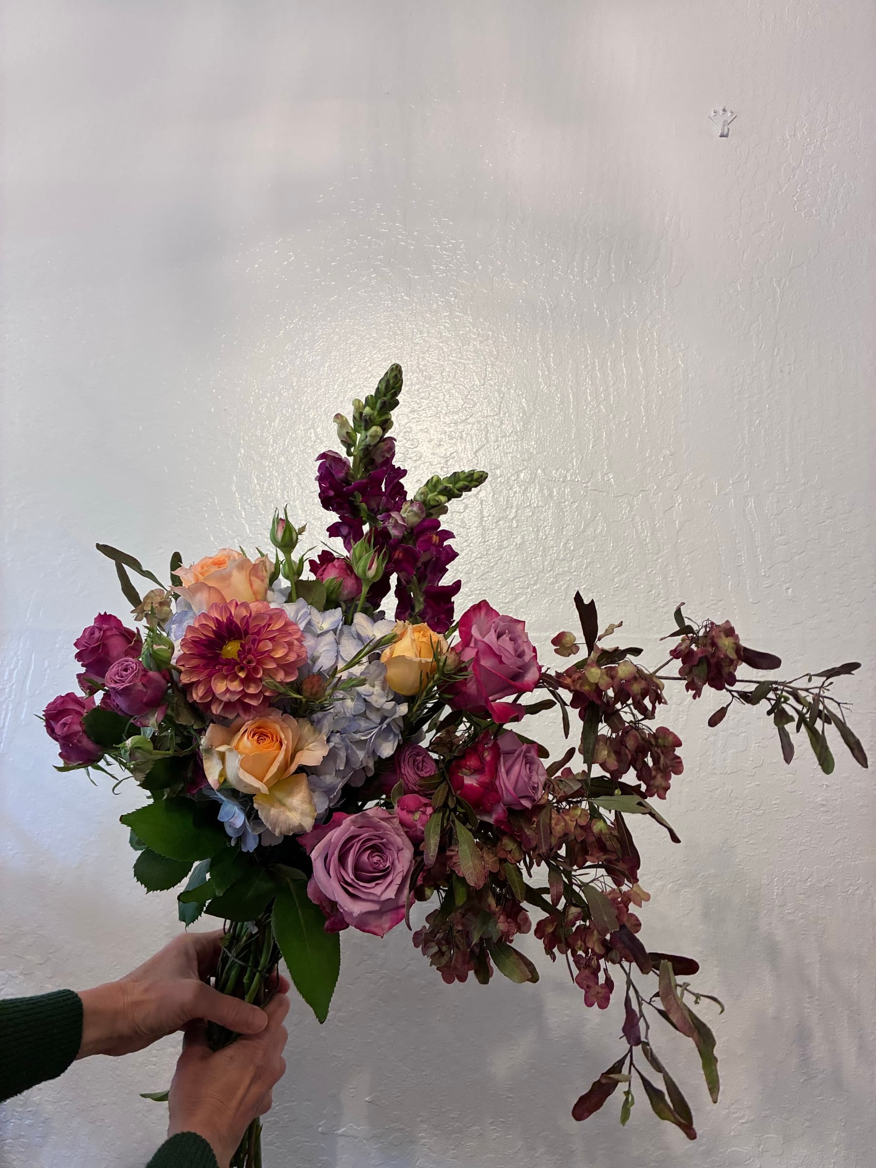 Autumn bouquet of roses, dahlias and plum foliage