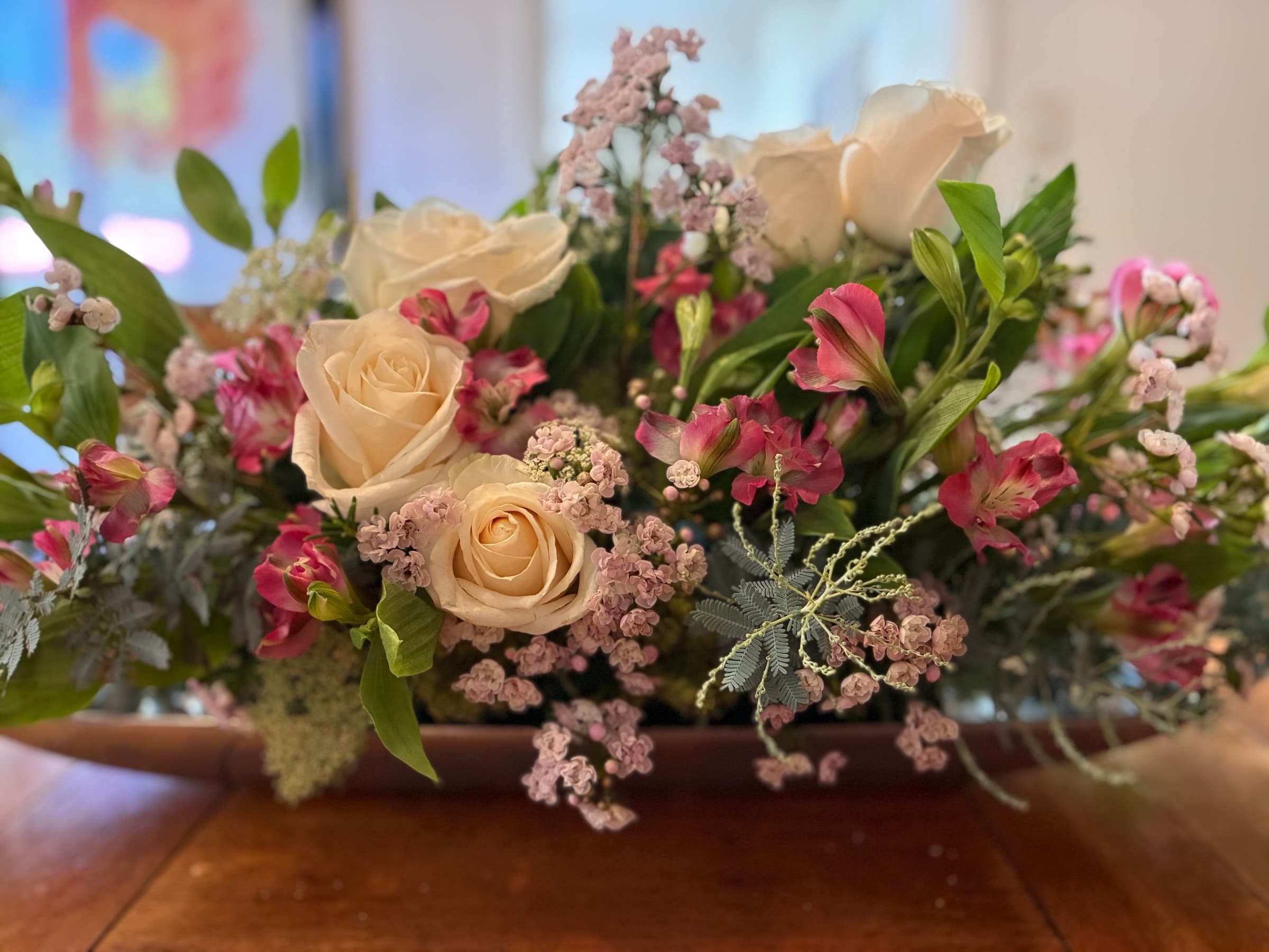 Long table centerpiece of cream roses and alstroemeria