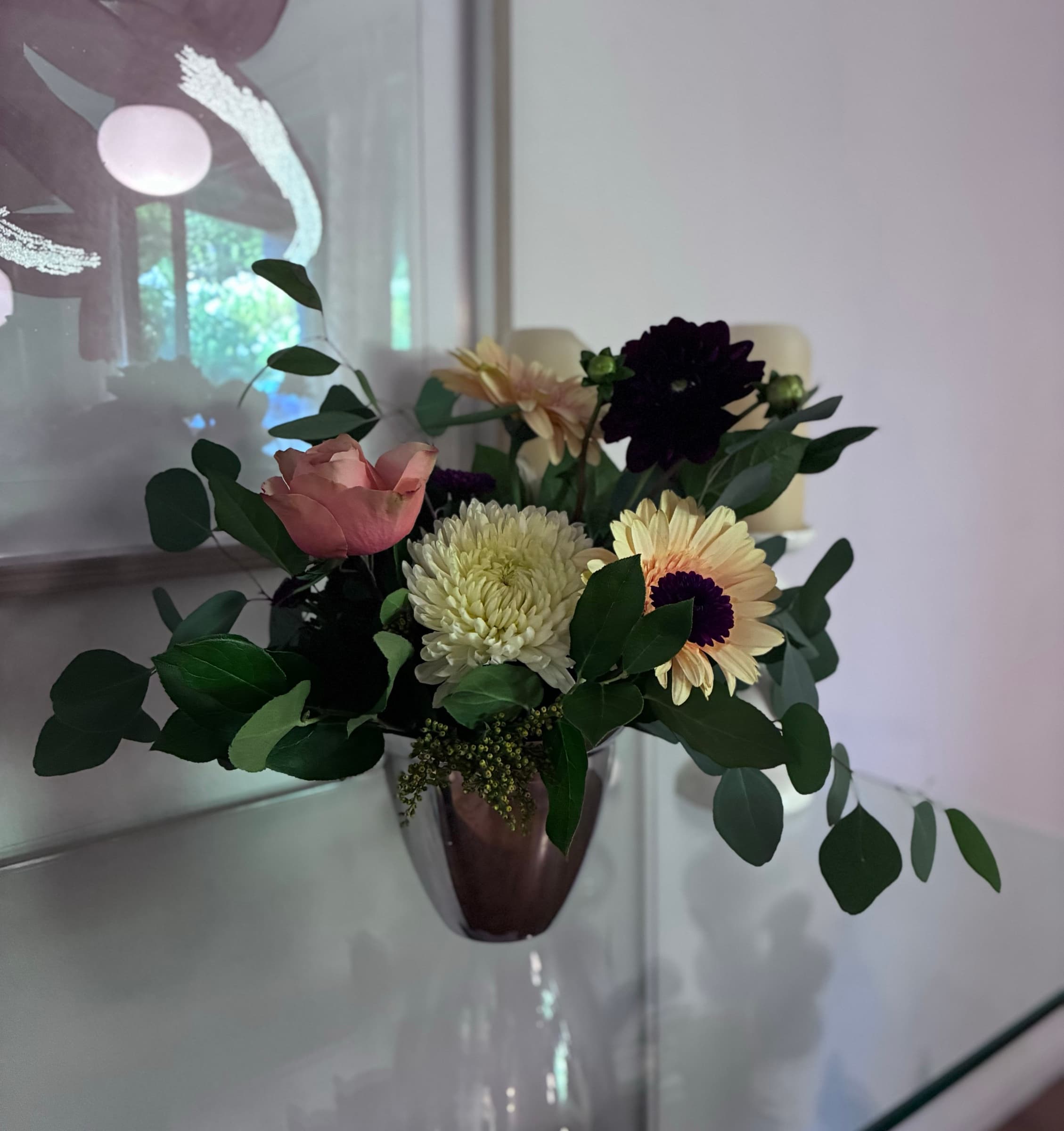Dahlias, chrysanthemum and garden roses in a silver vase
